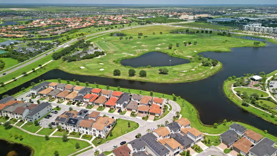 Aerial view of Sun City Center, Florida, with golf fairways, ponds, and tile-roofed homes